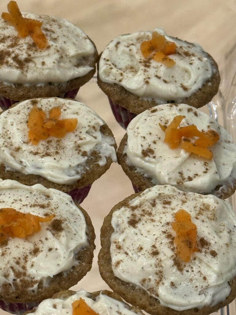 Carrot cake cupcakes with brown butter cream cheese frosting with grated carrot on top